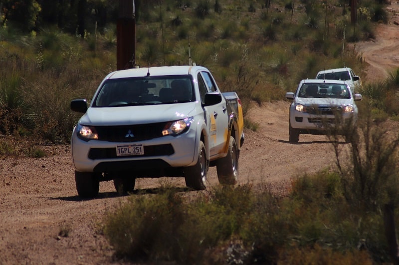 4WD's travelling on a sand track.