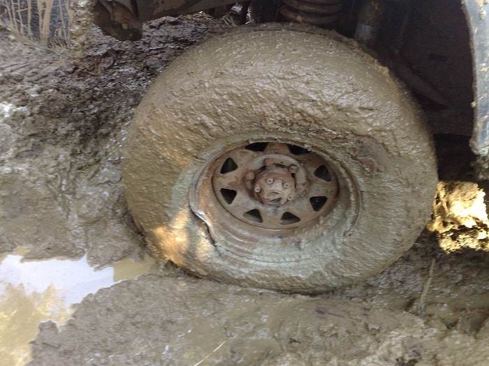 Closed-up of a tyre full of mud.