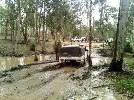 Toyota 4WD truck travelling on a muddy track.