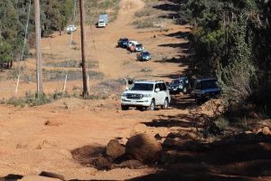 4WD trucks and vehicles travelling as a convoy in an off-road track.